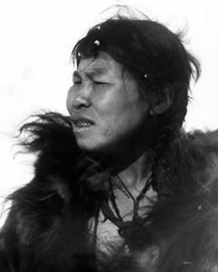 Chukchi woman with three fertility tattoos on cheek and a cruciform tattoo foil marking the corner of her mouth