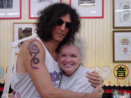 Superstar celebrity Howard Stern hugs tattoo artist Kate Hellenbrand after