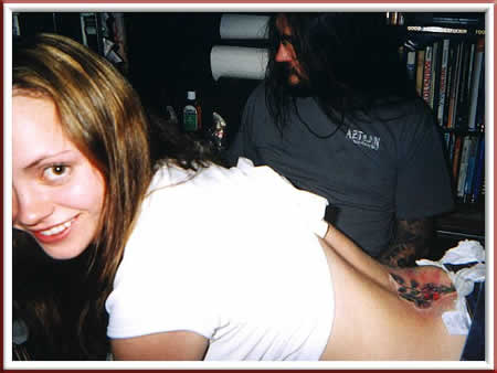 Christina Ricci getting sweet peas tattooed on her lower back by Thomas 