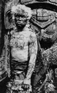 Chief Xa'na of Grizzly Bear House with tattooed hereditary crests, Masset, B.C., 1881
