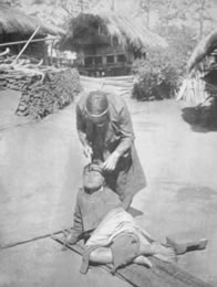 Hammering the tattoo home! An Atayal tattooist at work in 1910.