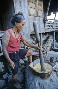 Pounding rice at dawn and a favorite pet, Lubo village. 