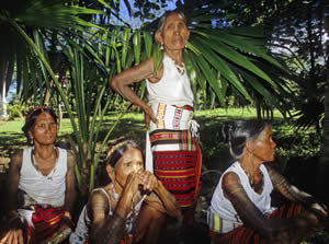 Kalinga women registering their names and villages before being photographed.  B) Tattooed women waiting for a portrait.
