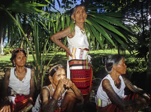 Kalinga women registering their names and villages before being photographed. B) Tattooed women waiting for a portrait.