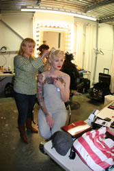 Model having her makeup applied for a photo shoot.